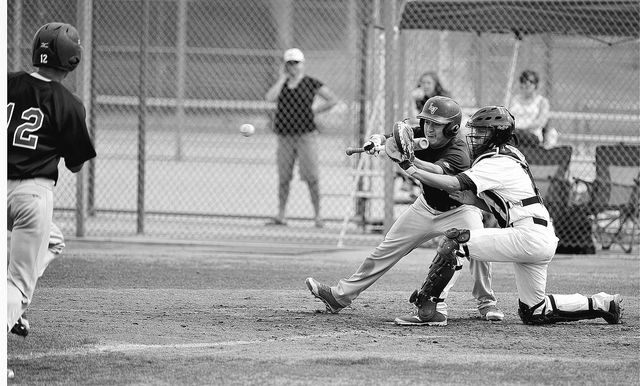 Shadow Ridge catcher Robbie Galvan steps forward to grab the ball as Las Vegas’ Kyle C ...