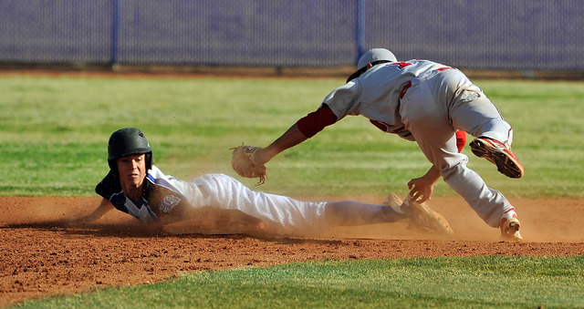 Basic’s Mikey York, left, avoids a tag by Liberty’s Ethan Ibarra as he steals se ...