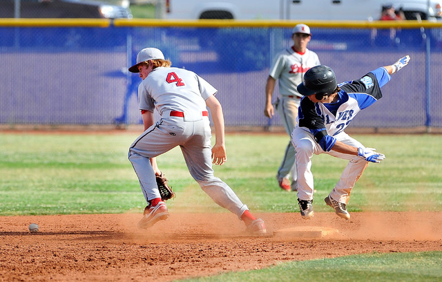 Basic’s Skyler Mahoney slides safely into second base as the ball gets by Liberty&#821 ...