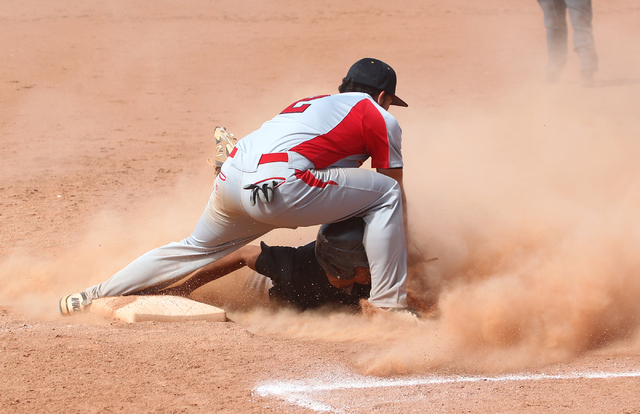 Chaparral’s Jose Ortiz (4) slides safely into third base as Tech’s Bryan Casas ( ...