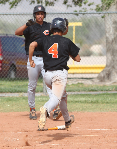 Chaparral’s Jose Ortiz (4) crosses home plate with a run against Tech at Silver Bowl P ...