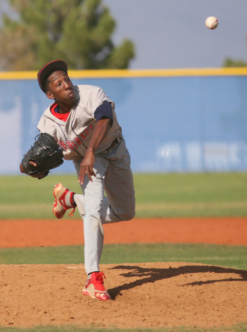 Coronado’s Donte Glover pitches and his hat lifts in the wind during a baseball game a ...