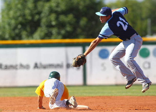 Rancho’s Braulio Santiaguin slides under the tag of Foothill shortstop Tyler Van Stone ...