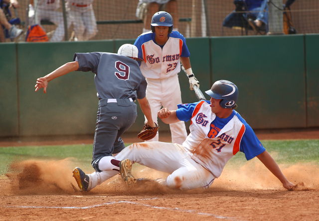 Bishop Gorman’s Nick Gates (21) scores on a wild pitch as Cimarron-Memorial pitcher Ty ...