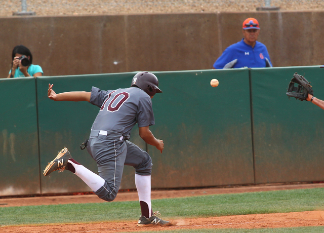 Cimarron-Memorial’s Luis Flores (10) is caught in a run down between home plate and th ...