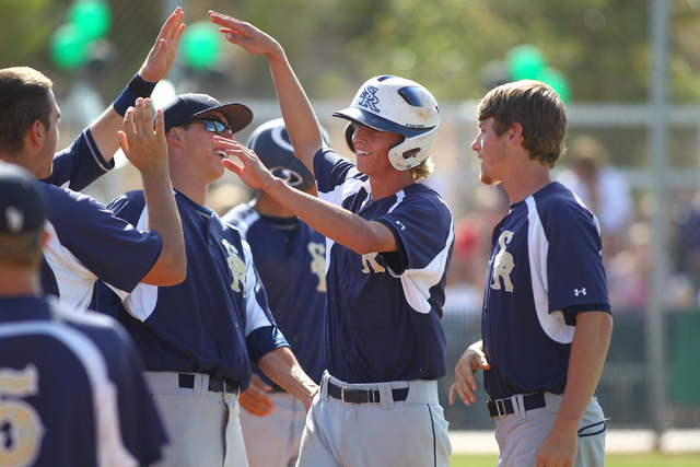 Shadow Ridge’s Travis Caskie, center right, celebrates with teammates after scoring a ...