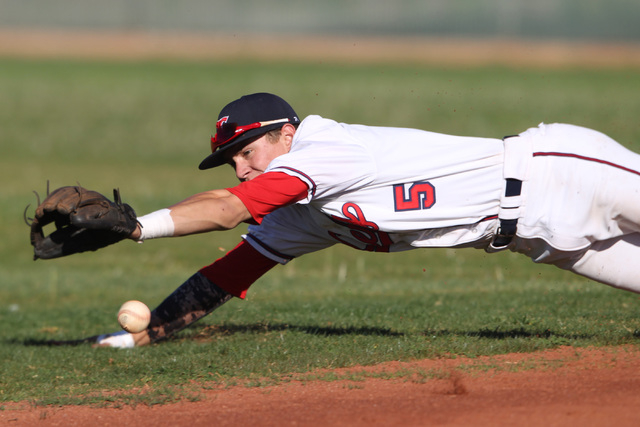 Liberty’s Nick Rush leaps and just misses a Basic ground ball during their game Thursd ...