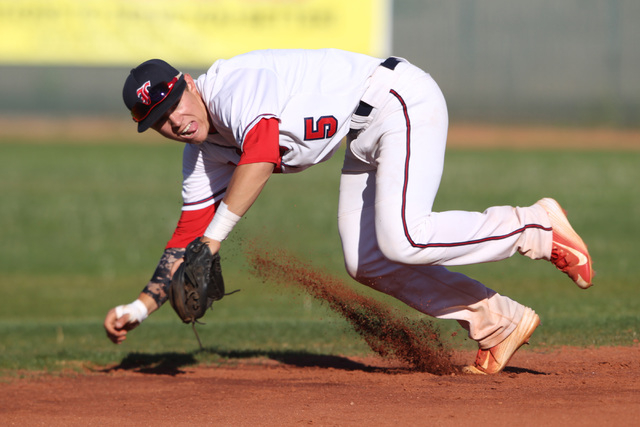 Liberty’s Nick Rush leaps towards a Basic ground ball during their game Thursday, Marc ...
