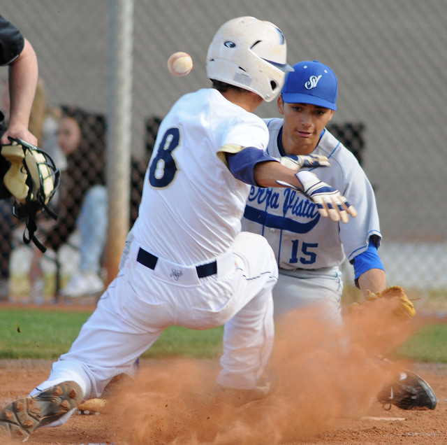 Shadow Ridge’s Tyler Burton (8) slides into home under Sierra Vista starting pitcher C ...