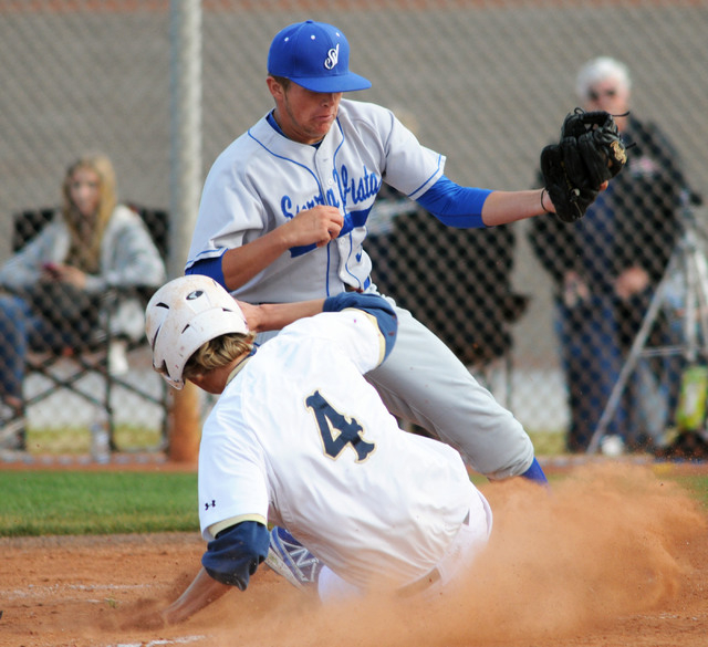 Shadow Ridge’s Travis Caskie (4) slides safely into home under Sierra Vista relief pit ...