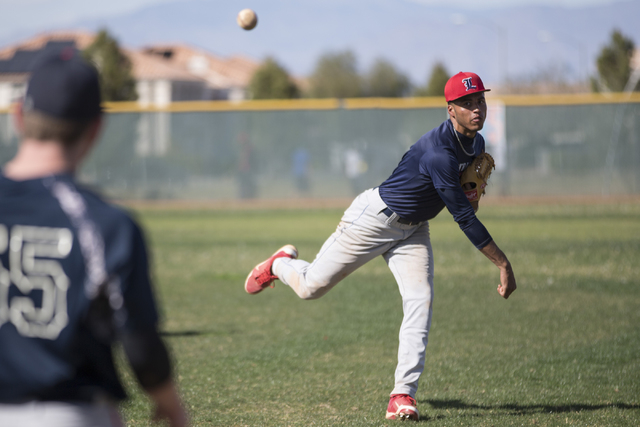 Liberty’s senior Ed O’Bannon throws the ball during a team practice at Liberty H ...