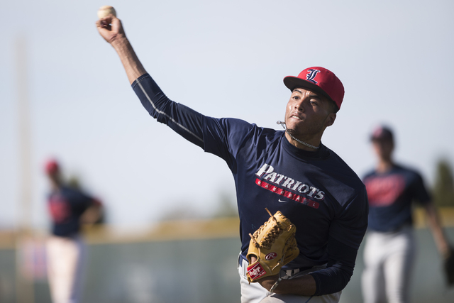 Liberty’s senior Ed O’Bannon throws the ball during a team practice at Liberty H ...