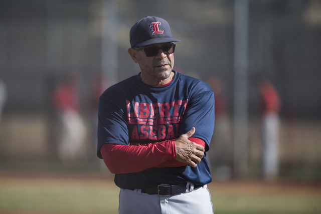 Wilfredo Rivera, first-year baseball coach at Liberty High School, looks over his team durin ...