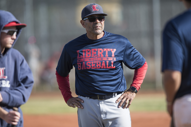 Wilfredo Rivera, first-year baseball coach at Liberty High School, looks over his team durin ...