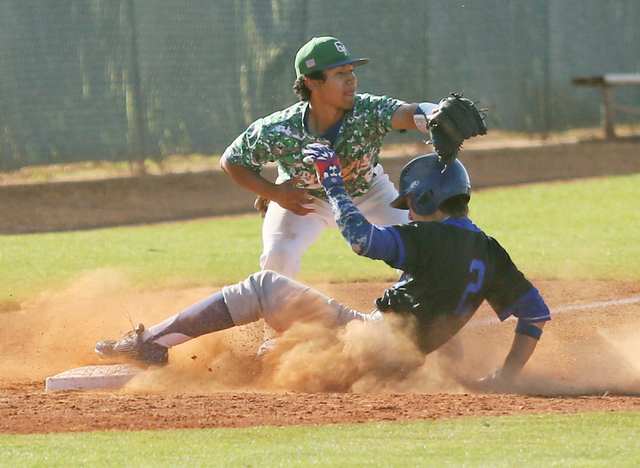 Basic’s Cory Wills, right, slides into third base as Green Valley’s Jimmy Montie ...