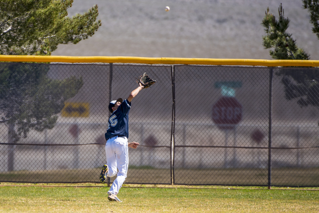 Shadow Ridge outfielder Koby Millner catches a fly ball against Desert Oasis at Shadow Ridge ...