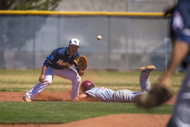 Desert Oasis’ Jake Lucas slides safely into second base as Shadow Ridge second baseman ...