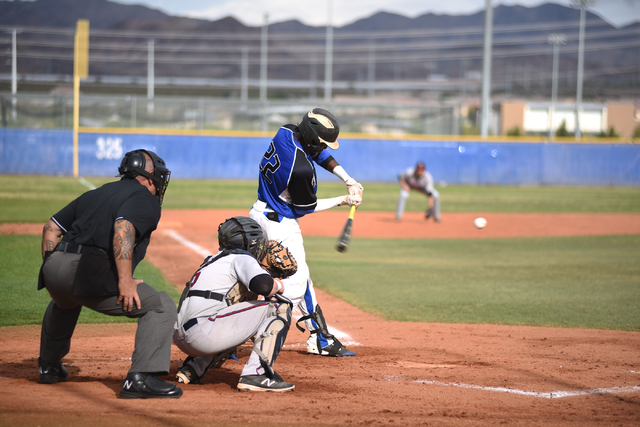 Basic’s J.J. Smith (22) swings at a pitch against Liberty during their baseball game p ...