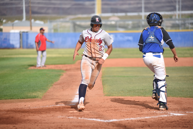 Liberty’s Omar Ortiz (2) scores a run against Basic during their baseball game played ...
