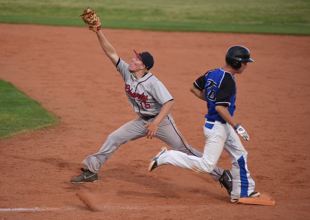 Basic’s Trent Bixby (26) is safe at first base against Liberty’s Justin Lutes du ...