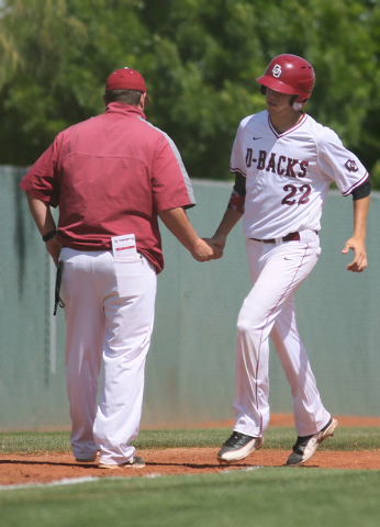 Desert Oasis senior Nolan Kingham, right, connects with assistant coach Colin McGrane while ...