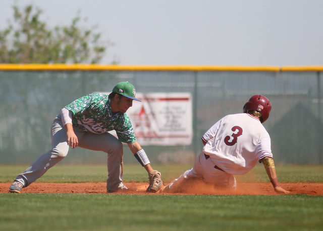 Green Valley’s A.J. Amelburu, left, goes for a tag as Desert Oasis’ Caeden Marin ...