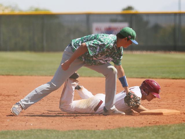 Green Valley’s Drake Maningo, left, goes for an out as Dominic Paratore slides back sa ...