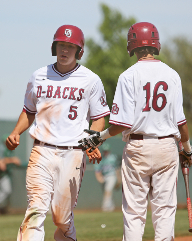 Desert Oasis’ Dominic Paratore, left, crosses home plate near Kyle Fuentes during a ba ...