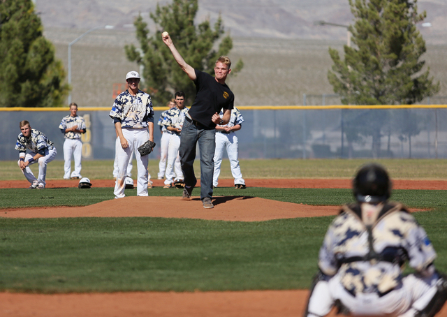 Shadow Ridge pitcher Chris Opolka, third from left, watches as Shadow Ridge graduate and Arm ...