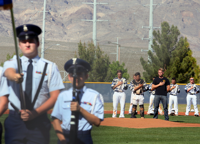 Shadow Ridge pitcher Chris Opolka, center from left, catcher Robbie Galvan and Shadow Ridge ...