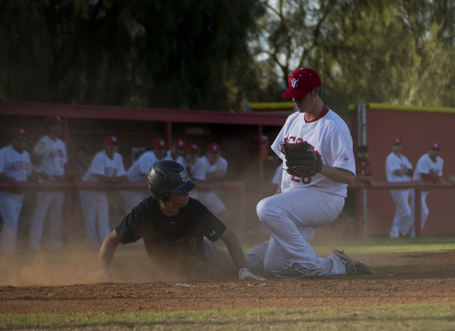 Faith Lutheran’s Sagan Groaner (15) slides into home plate as Arbor View’s Jaxon ...