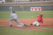 Las Vegas High School’s Jaime Solis (22) slides into third base as Las Vegas High Scho ...