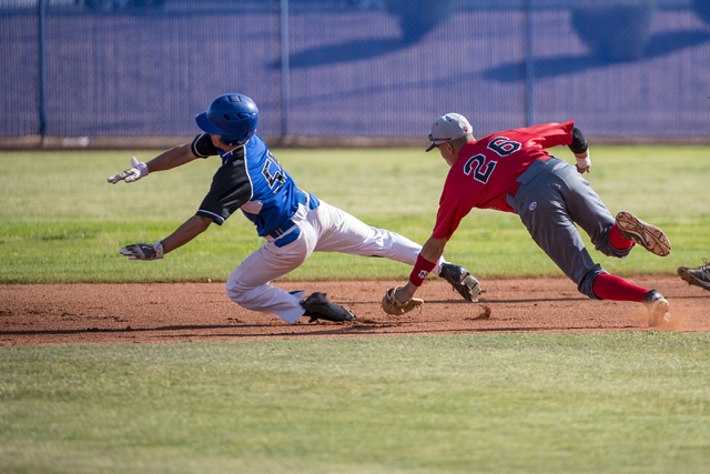 Basic’s Nick Thompson (55) is tagged out by Las Vegas High School’s Hector Perez ...