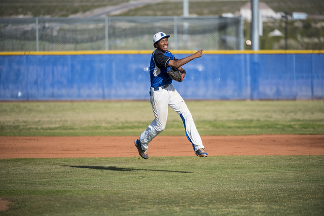 Basic’s Garrett Giles (17) throws the ball to first base while playing against Las Veg ...
