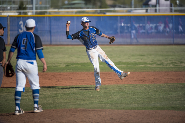 Basic High School’s Ryne Nelson (29) throws the ball to first base during a game again ...