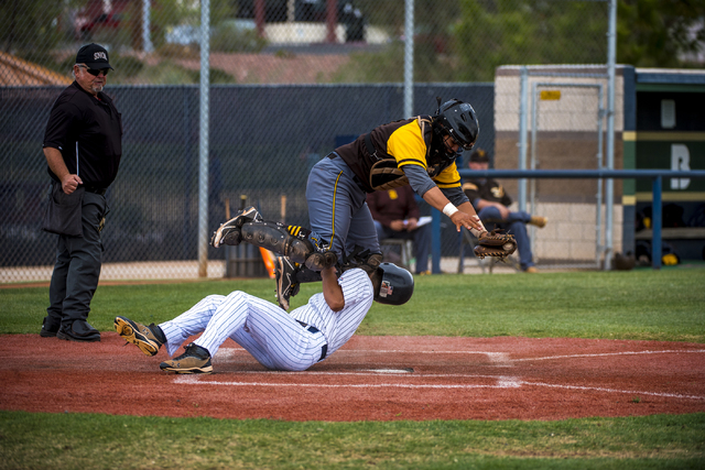 Spring Valley runner Antony Vazquez collides with Bonanza catcher Hilario Gomez-Soto (9) at ...