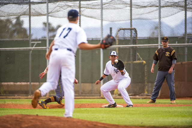 Spring Valley pitcher Jack Sellinger (17) throws the ball to first baseman Humberto Maldonad ...