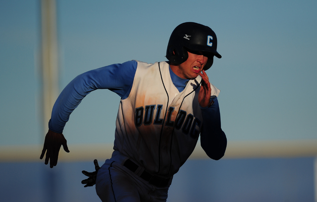 Centennial base runner Kyle Horton rounds third base to score a run against Liberty in the f ...