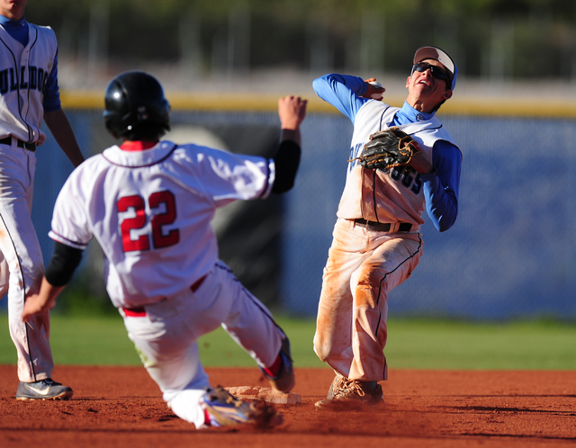 Centennial second baseman Bryce Rheault attempts to turn a double play as Liberty base runne ...
