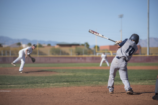 Spring Valley’s Shayne Watkins (10) swings for a strike against Faith Lutheran high sc ...