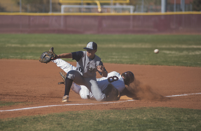 Faith Lutheran’s Alex Giuliani (8) slides back to first base as Spring Valley’s ...