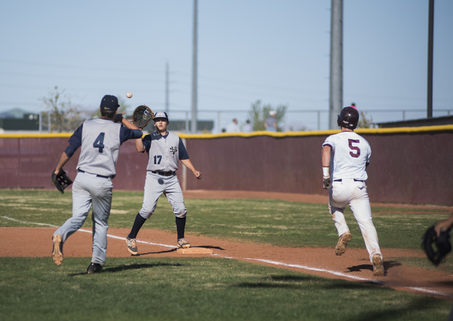 Faith Lutheran’s Greg Sylvester (5) hussles to first base as Spring Valley’s Bry ...