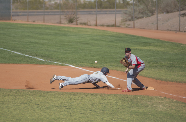 Boulder City’s Zach Murphy (3) slides back to first before being tagged by Tech’ ...