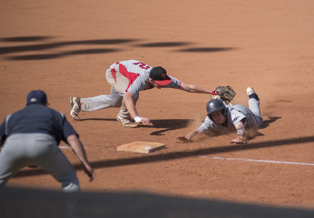 Boulder City’s Nolan Desantis (1) is tagged out at third base by Tech’s Trevor K ...