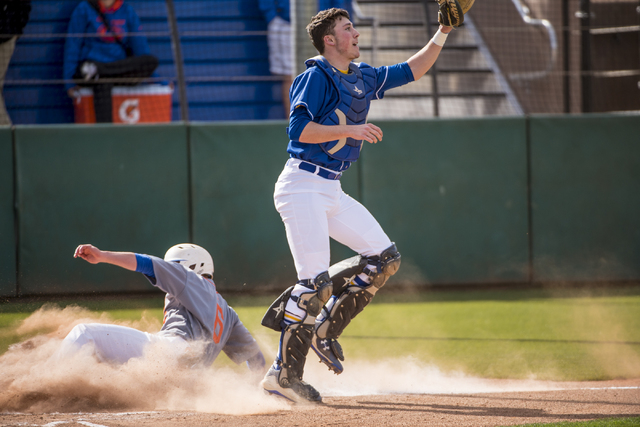 Bishop Gorman infielder Beau Capanna (6) slides safely into home against O’Gorman High ...