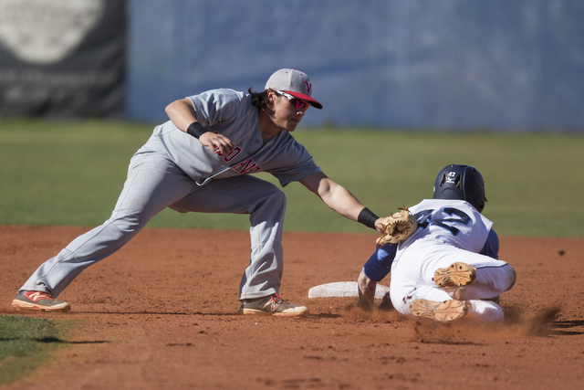Arbor View’s Nick Quintana (12) tags out Centennial’s Jake Rogers (42) in their ...