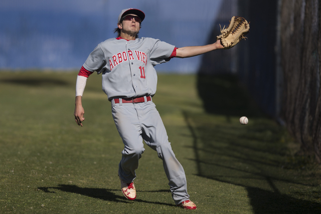 Arbor View’s Jayce Gardner (11) misses a catch in foul territory against Centennial in ...
