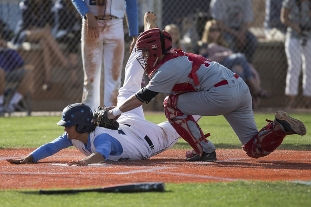 Arbor View’s Joe Fitzhugh (16) tags Centennial’s Frank Sessa (10) for an out at ...