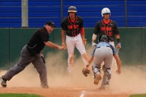 Bishop Gorman base runner Jorel Hingada reacts after being called out at home plate by umpir ...