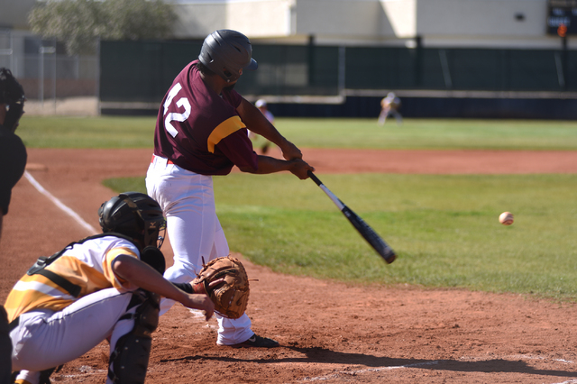 Pahrump Valley’s Aaron Fuentes (42) swings at a pitch against Clark during their baseb ...